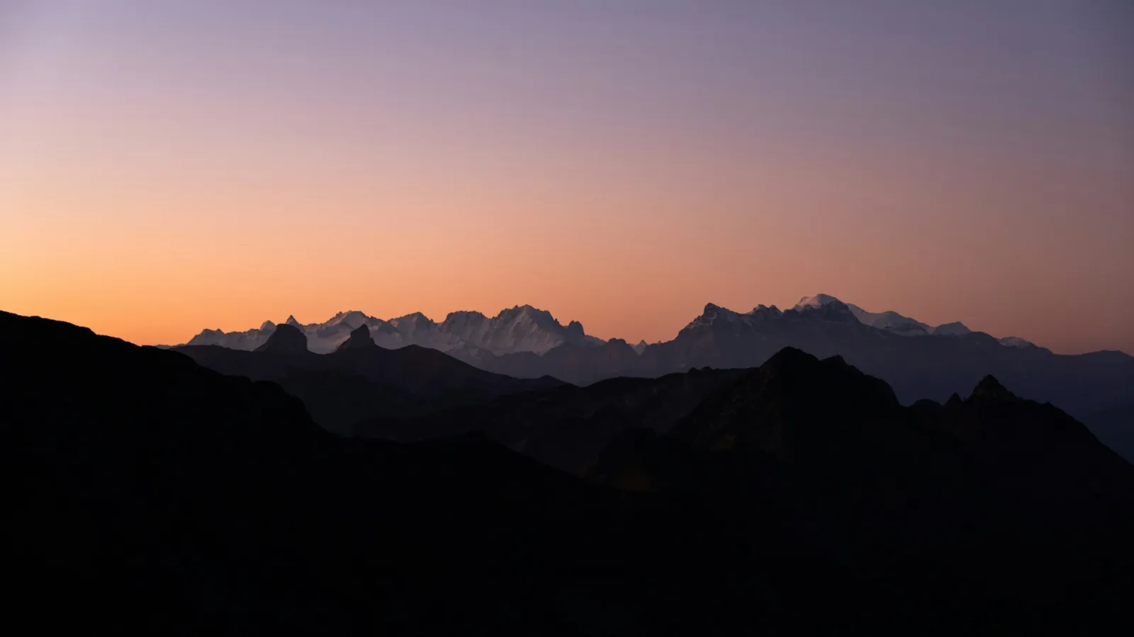 Alpenglow over the Dents du Midi peaks in the Swiss Alps at dusk